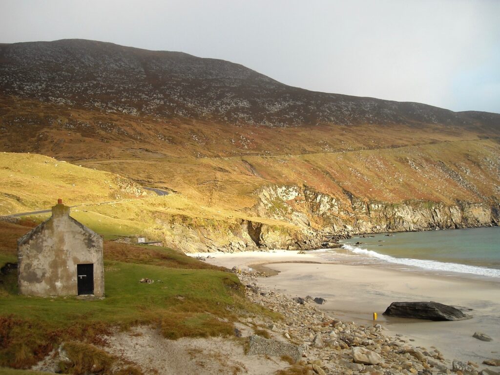The beach at Achill Island, with beautiful landscape towering over it.